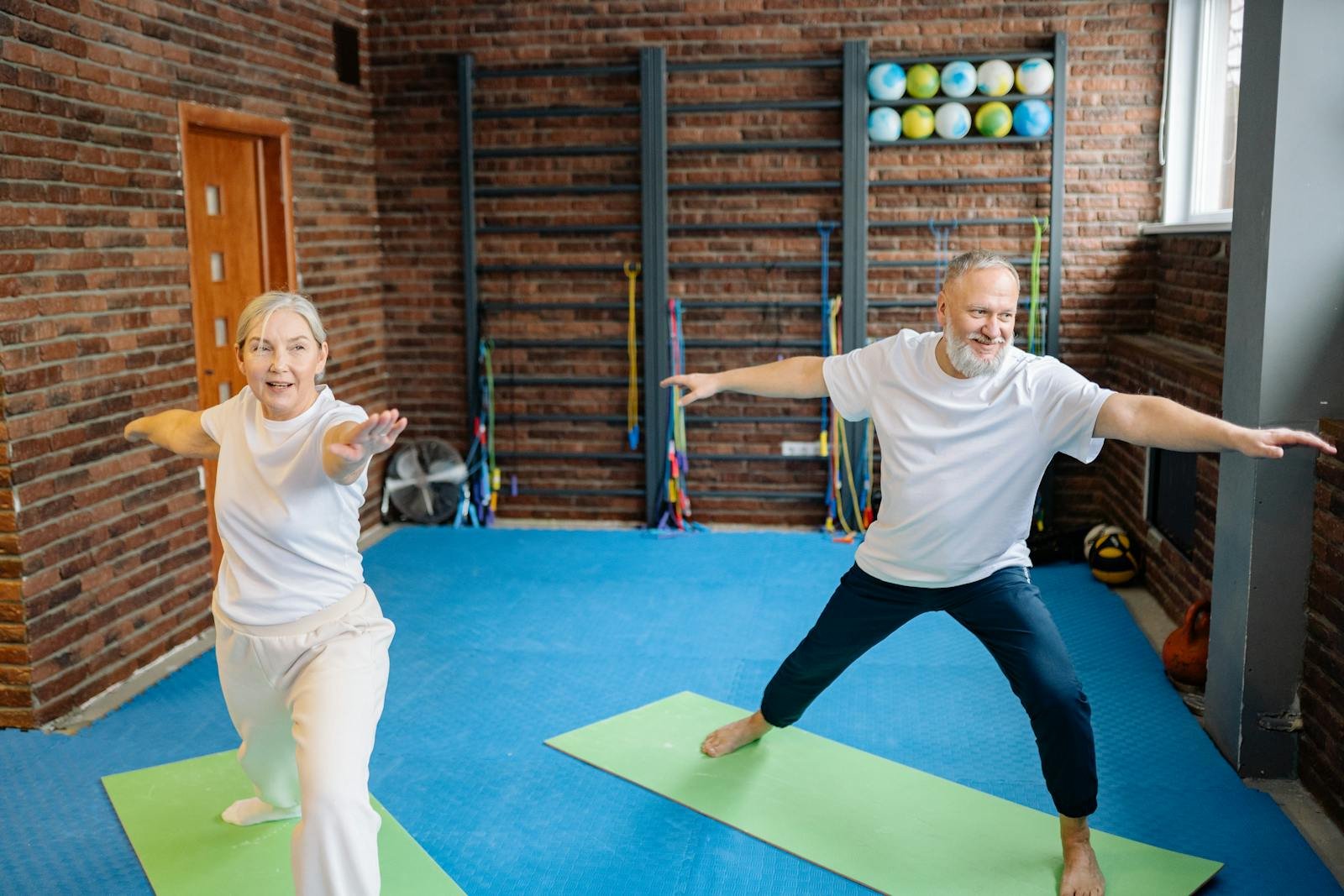 Couple practising yoga on mats together